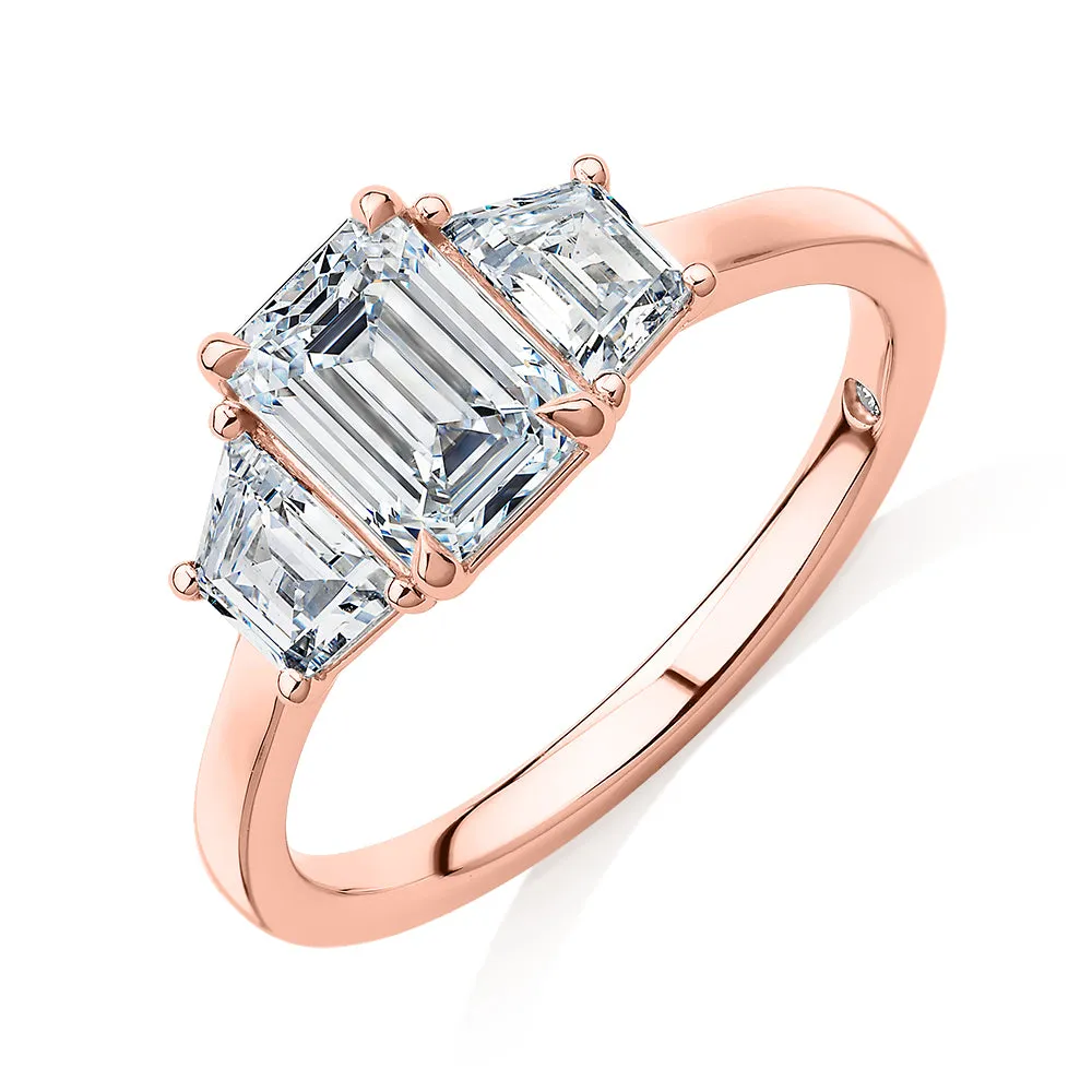 Signature Simulant Diamond 1.87 carat* TW emerald cut three stone ring in 14 carat rose gold