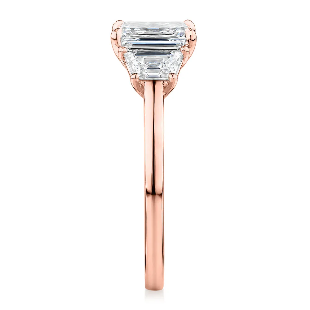 Signature Simulant Diamond 1.87 carat* TW emerald cut three stone ring in 14 carat rose gold