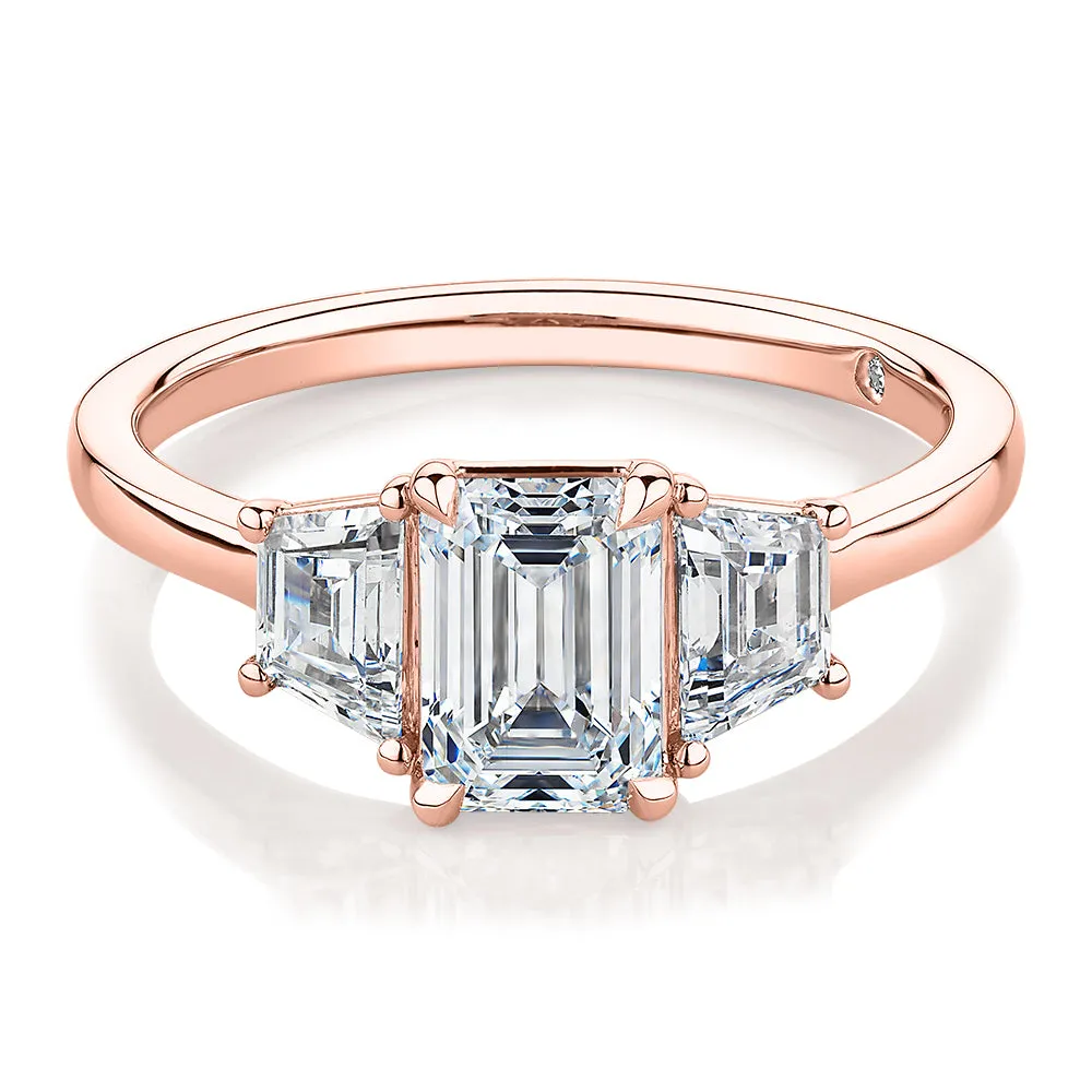 Signature Simulant Diamond 1.87 carat* TW emerald cut three stone ring in 14 carat rose gold