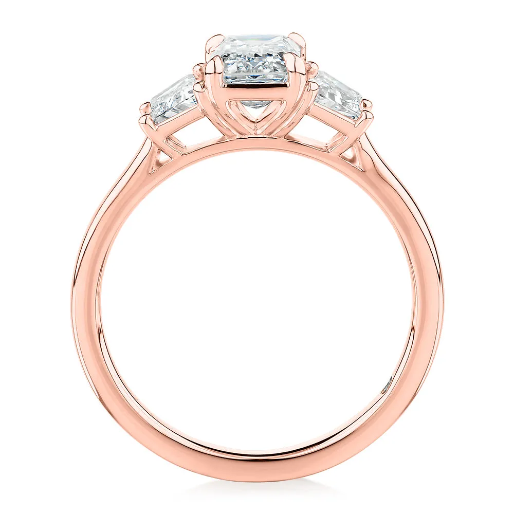 Signature Simulant Diamond 1.87 carat* TW emerald cut three stone ring in 14 carat rose gold